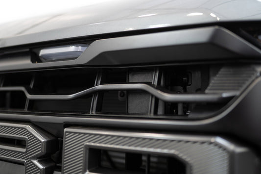 ADD AC1305101NA adaptive cruise control relocation bracket installed behind grille on 2024-2026 Ford F-150 Raptor