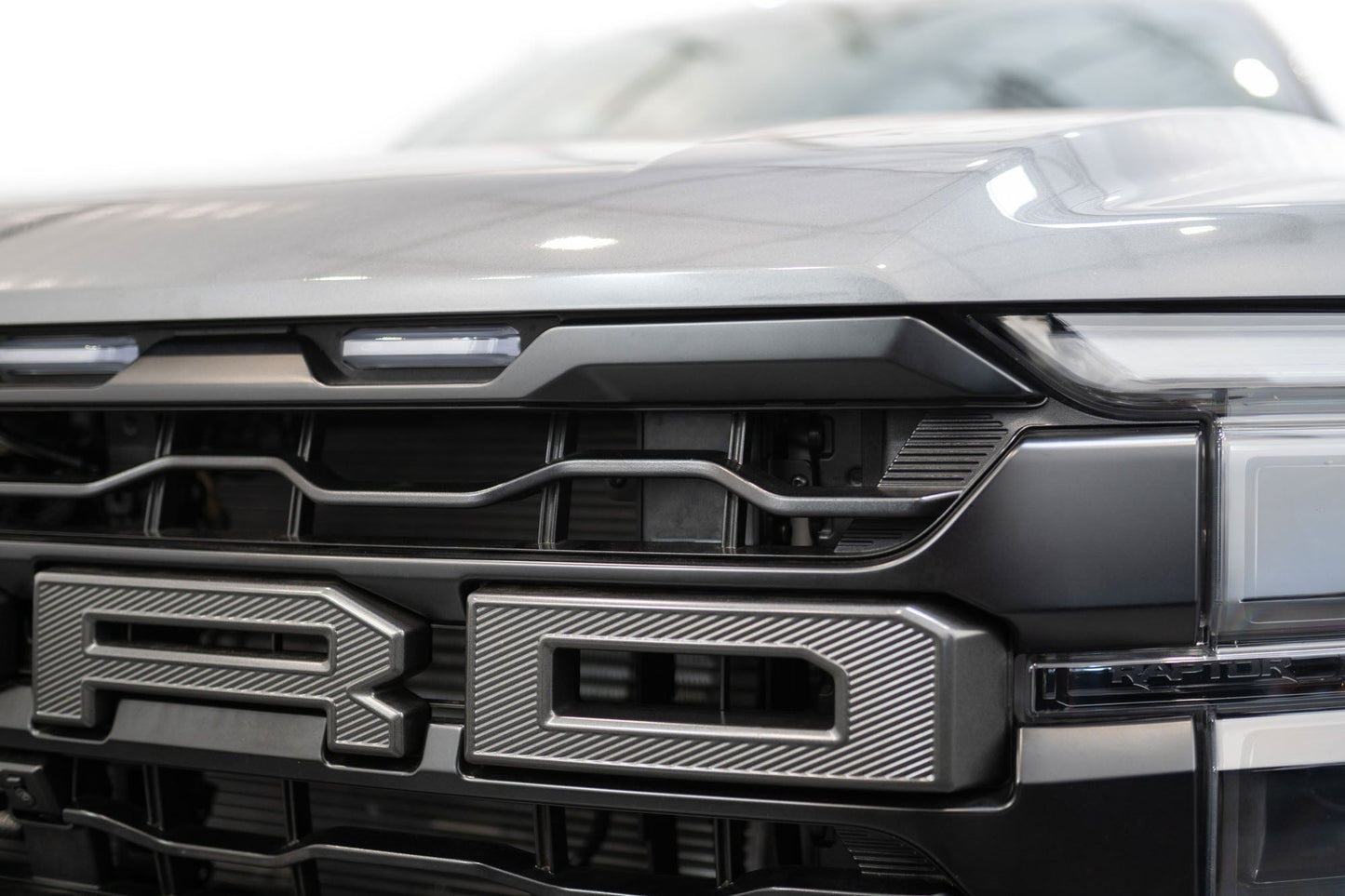 ADD AC1305101NA adaptive cruise control relocation bracket detail for 2024-2026 Ford F-150 Raptor